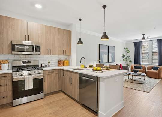 A modern kitchen with wooden cabinets and stainless steel appliances at Union Eleven Apartments, Georgia 30324