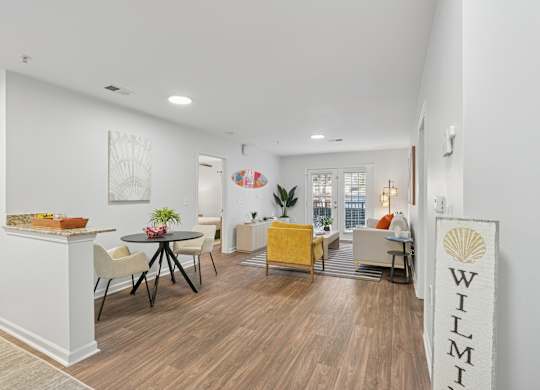 A living room with a wooden floor and furniture.