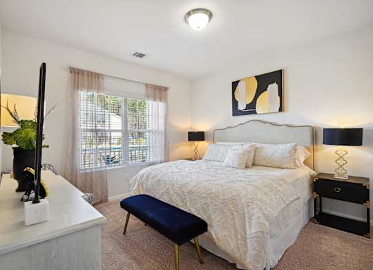 Bedroom with a bed and a dresser and a window  at The Meadows, Bloomingdale, GA, 31302