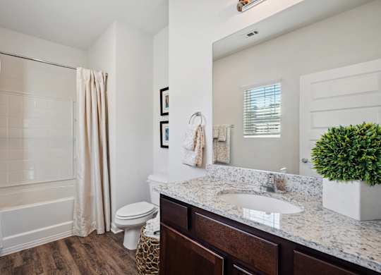 Bathroom with a sink and a toilet and a shower  at The Meadows, Bloomingdale, Georgia