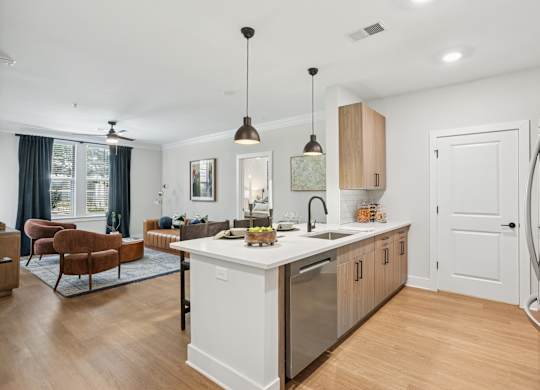 A modern kitchen with a white fridge and wooden cabinets at Union Eleven Apartments, Atlanta, GA 30324