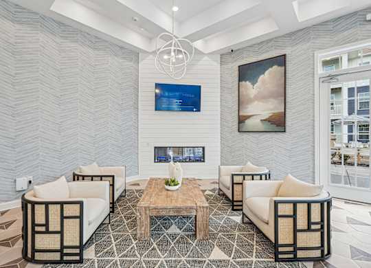 A modern living room with a fireplace and a painting on the wall.at The Parker Leland, Leland