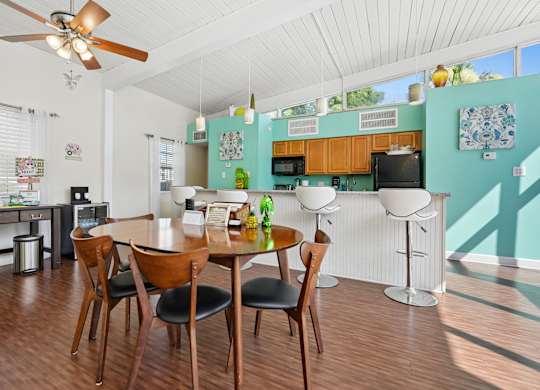 A kitchen with a table and chairs in the middle of the room.
