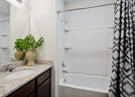 Bathroom with a shower and a sink and a mirror  at The Meadows, Bloomingdale, GA