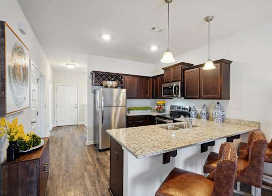Kitchen with stainless steel appliances and a granite counter top at The Meadows, Bloomingdale, GA, 31302