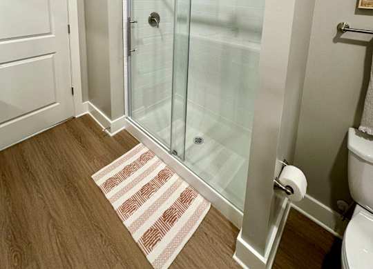 A bathroom with a walk-in shower and a toilet at The Collective Upper Westside Apartments, Atlanta, GA, 30318