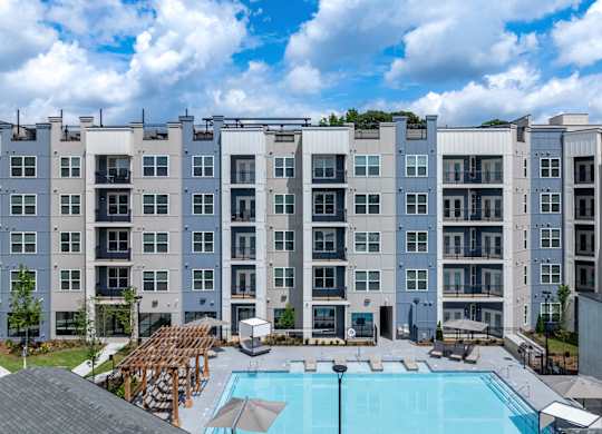 A large apartment complex with a pool in the courtyard at The Collective Upper Westside Apartments, Georgia