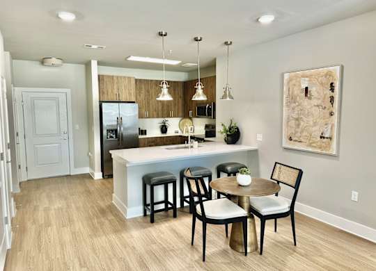 A kitchen with a table and chairs at The Collective Upper Westside Apartments, Atlanta, 30318