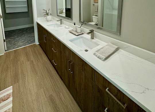 A bathroom with a white sink and a large mirror at The Collective Upper Westside Apartments, Atlanta, GA