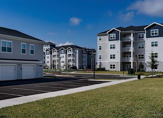 Apartment complex with a parking lot in front at The Waverly at Winter Haven Apartments, Florida