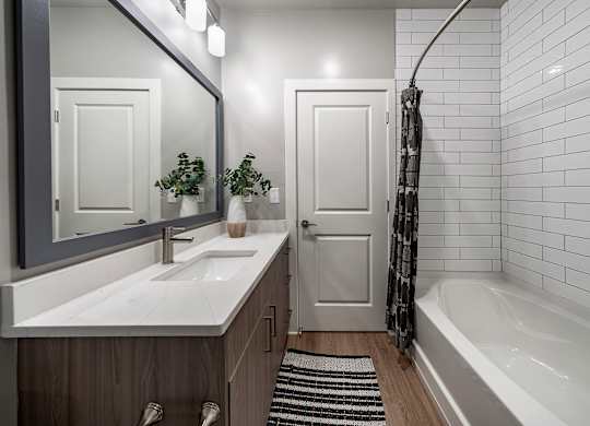 A white sink with a mirror above it at The Waverly at Winter Haven Apartments, Florida