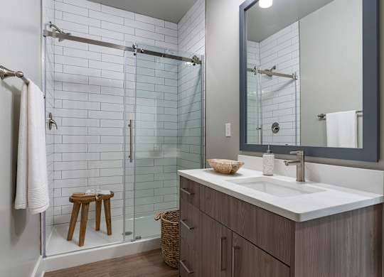 A bathroom with a white sink and a mirror at The Waverly at Winter Haven Apartments, Winter Haven, FL, 33884