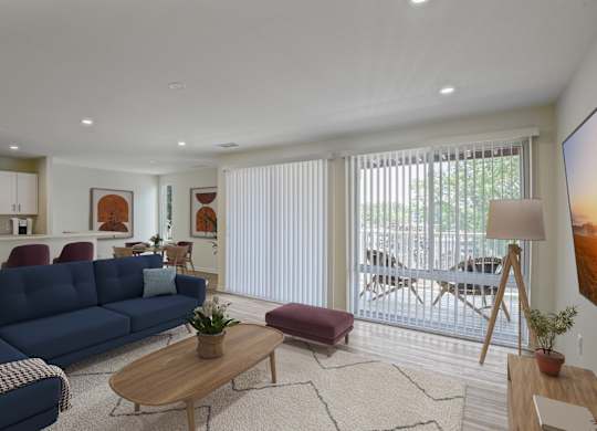 A blue sofa sits in a living room with a wooden coffee table in front of it.