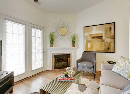 a living room with a couch and a chair and a fireplace
