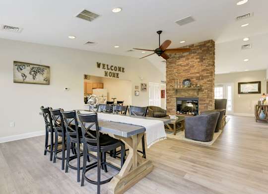 a dining room with a table and chairs in front of a fireplace