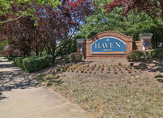 A sign that says Haven Largo is in front of a tree.