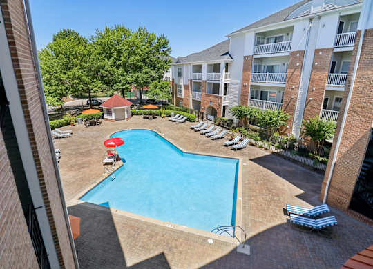 A pool surrounded by apartment buildings.