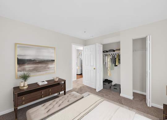 A bedroom with a bed, a dresser, and a painting on the wall.