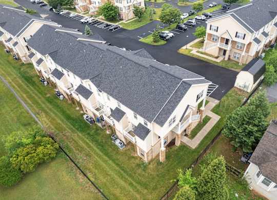 A bird's eye view of a residential area with houses and cars.