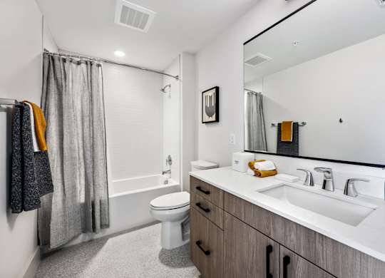 A bathroom with a white toilet, a white sink, and a white bathtub.