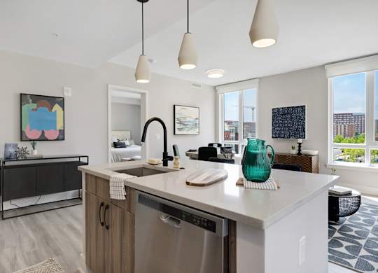 A kitchen with a white counter top and a washing machine.