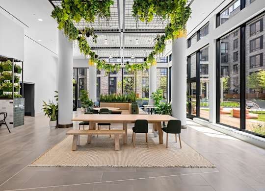 A modern dining area with a long table and chairs.