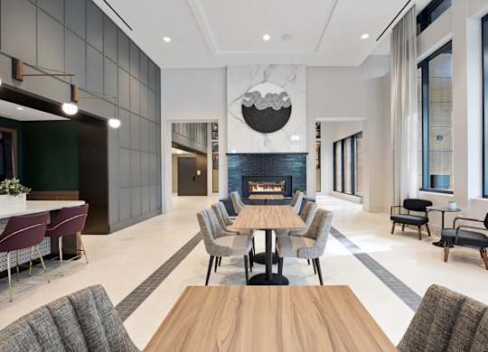 A modern dining room with a wooden table and chairs.