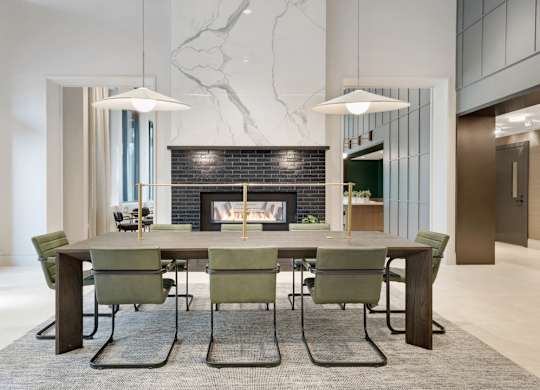 A modern dining room with a large table and chairs.