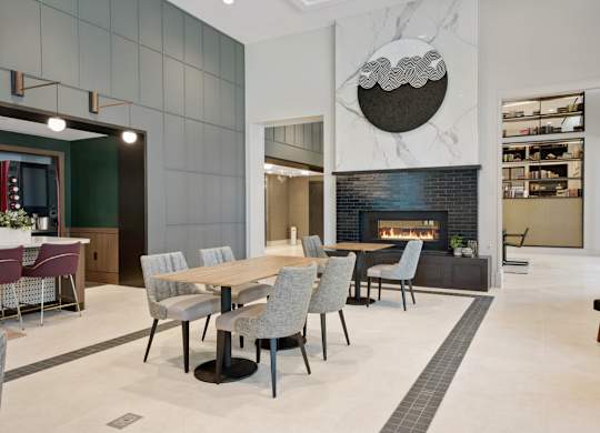 A modern dining room with a fireplace and a TV.