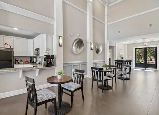 A dining room with a table set for four.