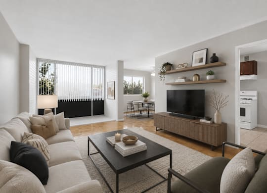 A modern living room with a large couch, a coffee table, and a television.
