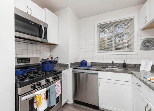 A kitchen with a stove, microwave, and dishwasher.