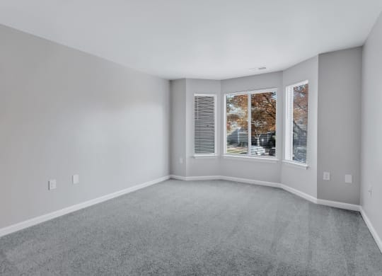 an empty living room with a large window