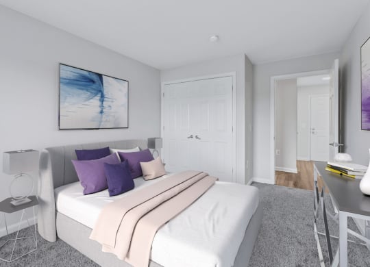 a bedroom with a white bed and purple pillows
