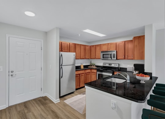 a kitchen with white appliances and wooden cabinets