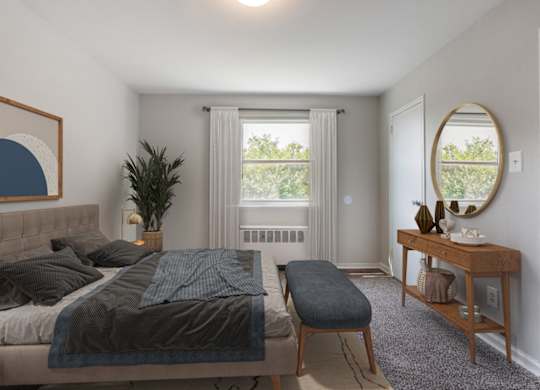 A bedroom with a bed, a bench, and a mirror.