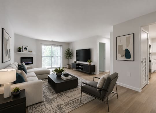 A modern living room with a white couch, a black chair, and a coffee table.