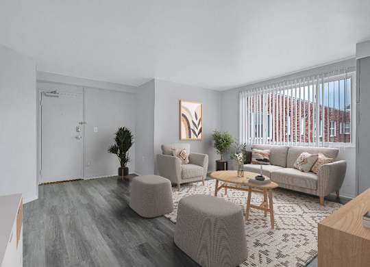 A living room with a grey couch, a wooden coffee table, and a painting on the wall.