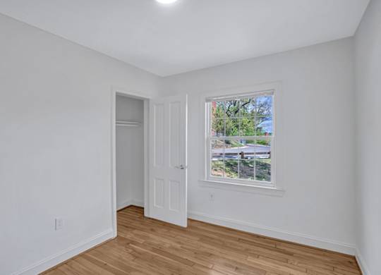 A room with a window and a door.