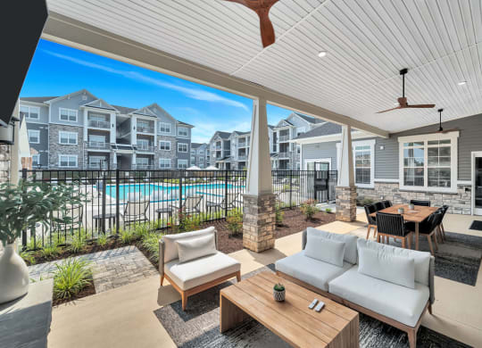 a living room with a view of a pool and an apartment building