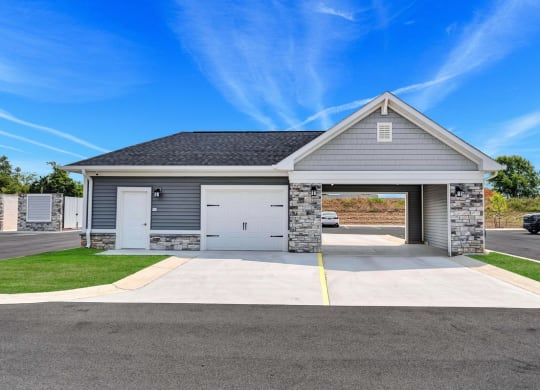 the front of a house with a driveway and a garage door