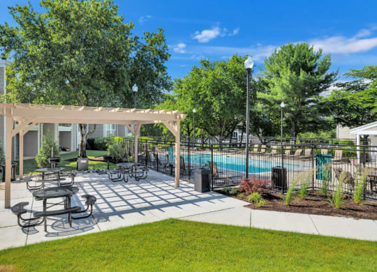 our apartments have a pool and a patio with tables and chairs