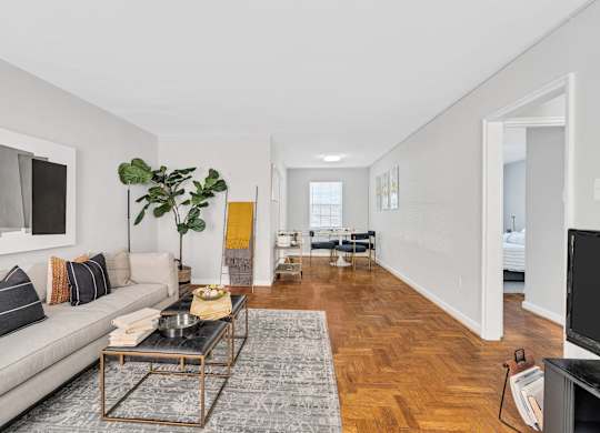 A living room with a grey couch and a coffee table.