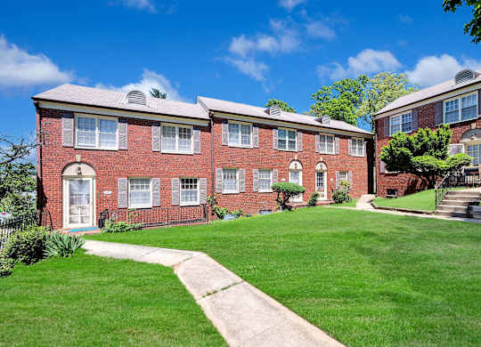 A red brick building with a white door and windows.
