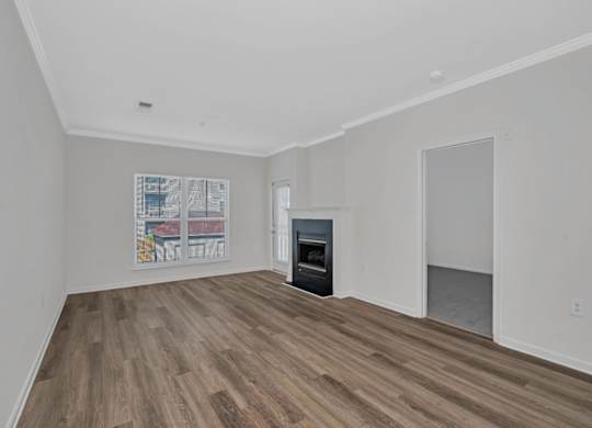 A room with a fireplace and a poster on the wall.