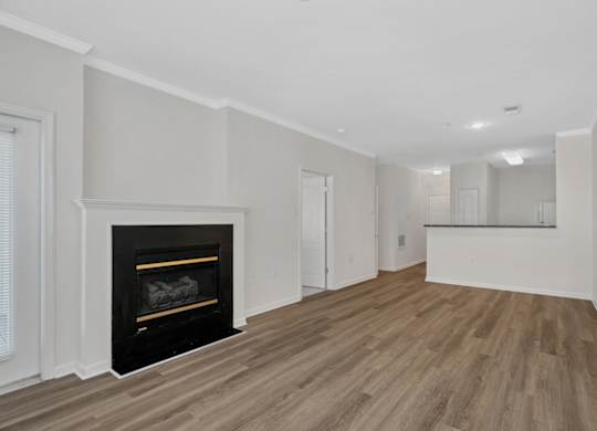 A room with a fireplace and wooden floors.