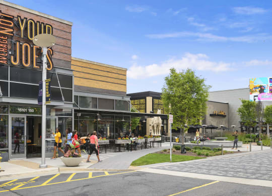 a rendering of a shopping center with people walking on the sidewalk