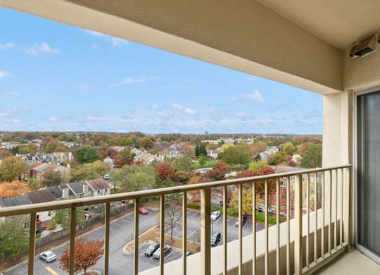 A balcony overlooks a residential neighborhood.
