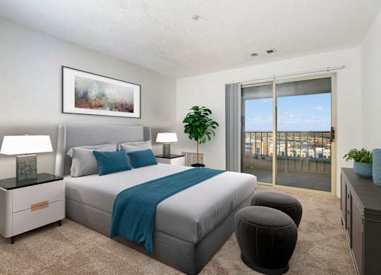 A bedroom with a large bed and a view of the city.