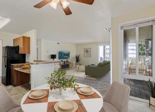 A dining room with a table set for a meal.